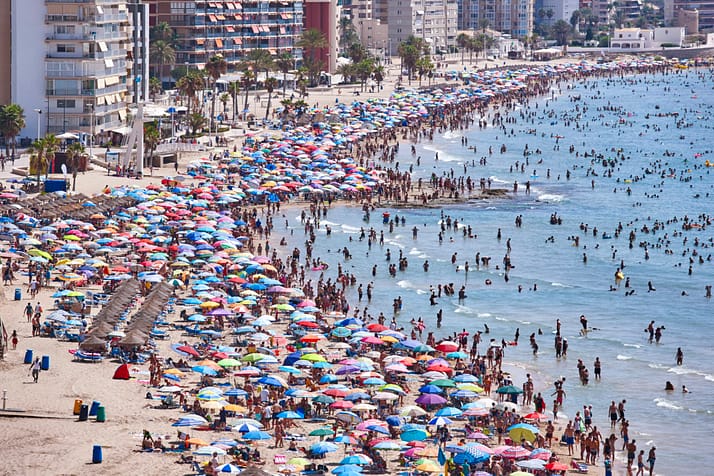 Mediterranean coastline in Spain. Calpe beach. Summer crowd. Alicante seascape